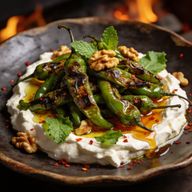 Hearth-Blistered Shishitos over Whipped Feta photo 1